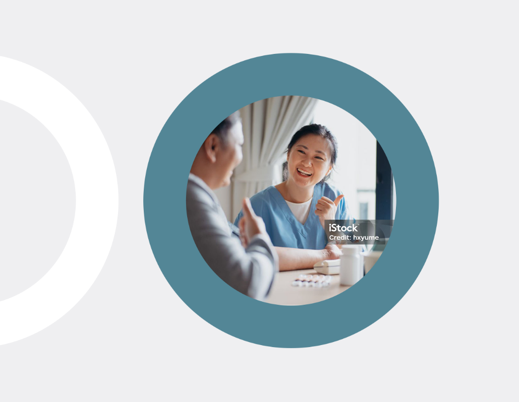 An asian doctor speaking to a patient, in a blue circle